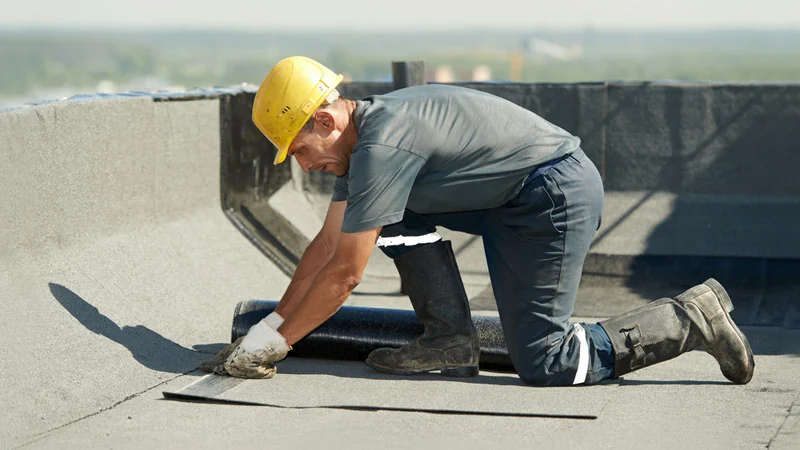 Worker wearing a hard hat while working on a roof