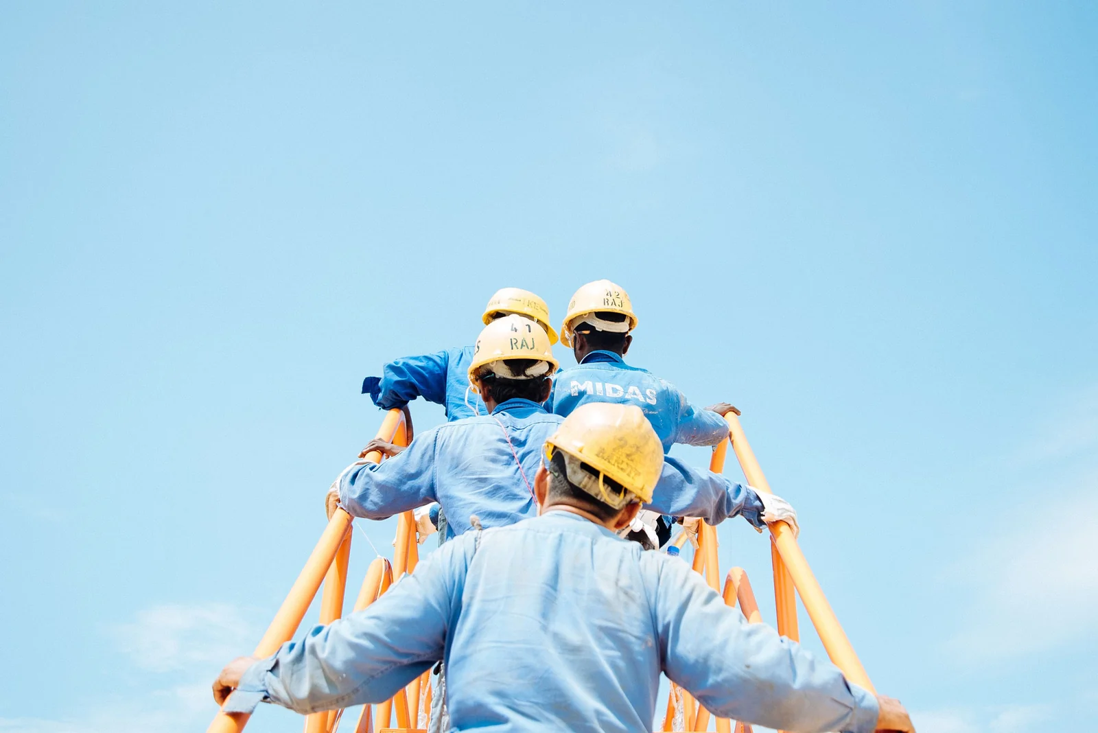 Utility workers wearing hard hats on an elevated work platform